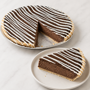 Sliced chocolate silk pie showing the filling, crust and a generous slice ready to serve